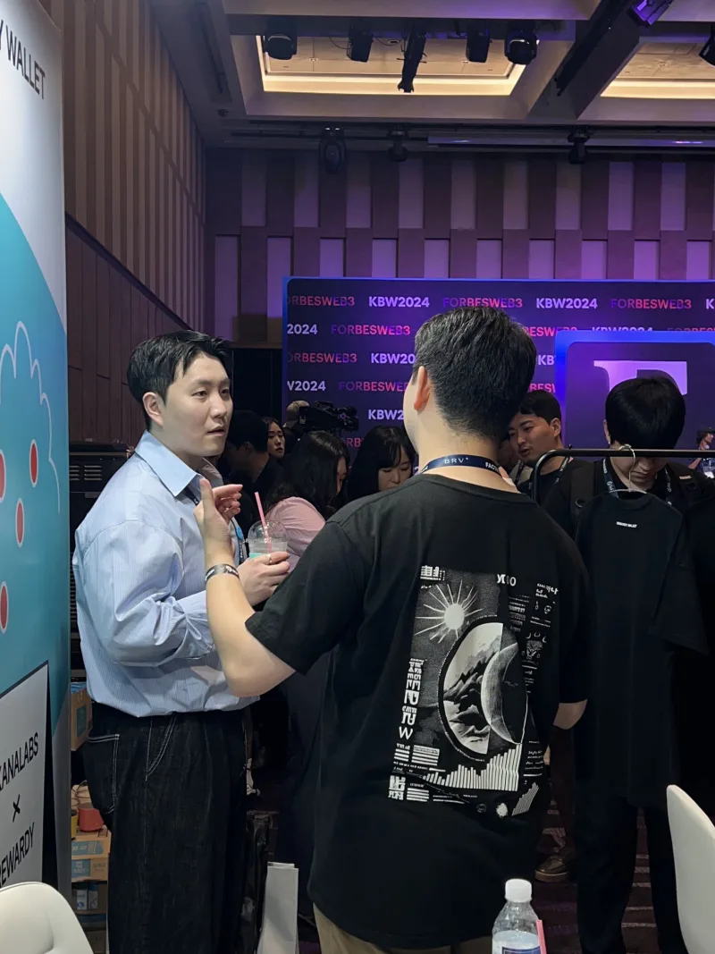 Photograph of an attendee wearing the moon graphic tee at Korea Blockchain Week 2024